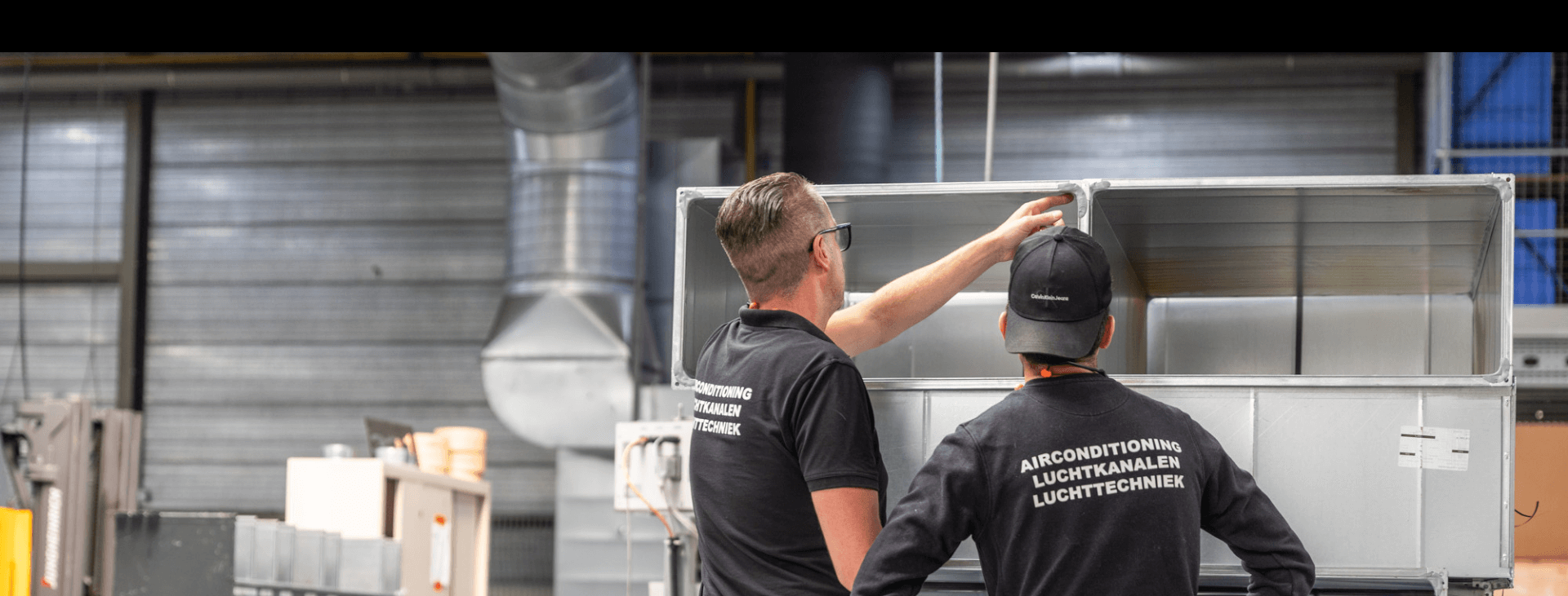 Twee medewerkers van schilt in werkplaats in Meerkerk